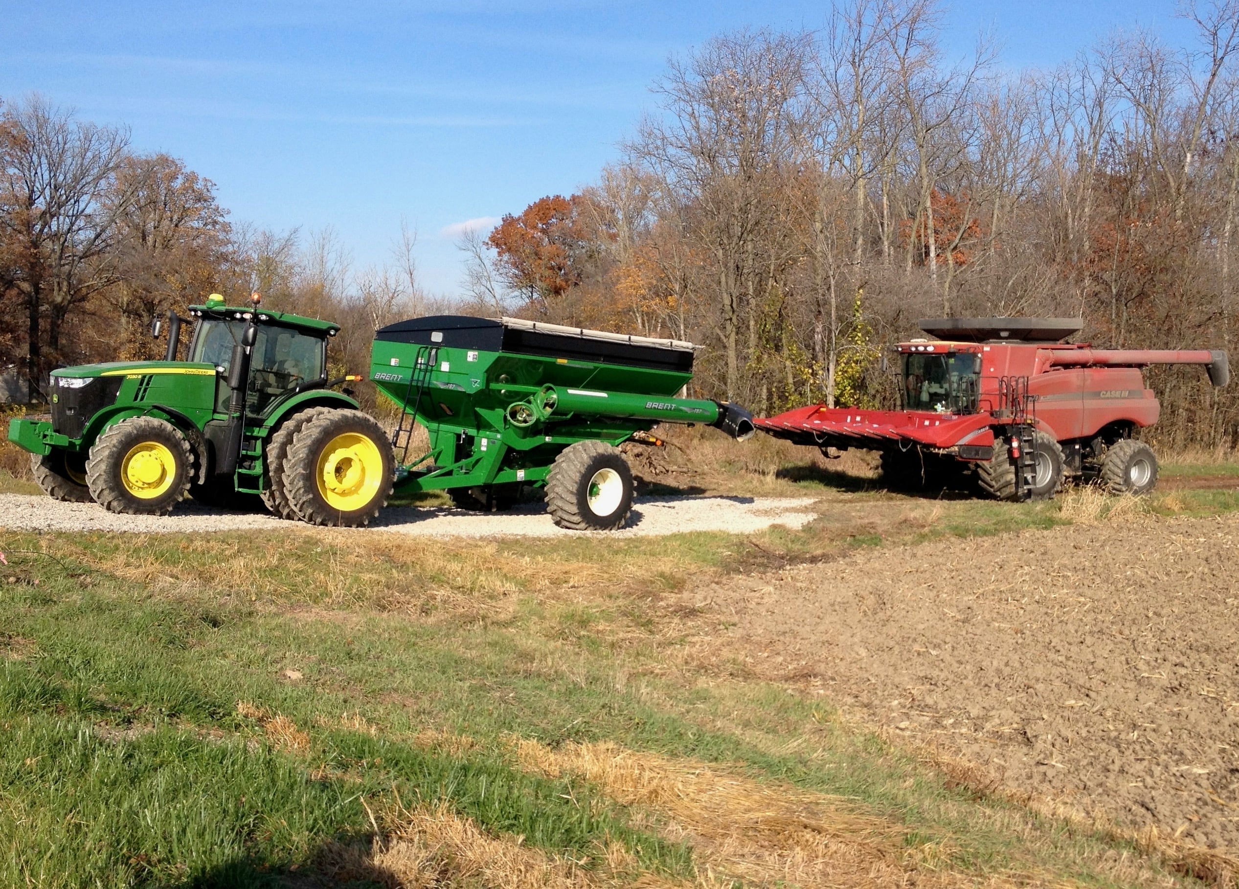 John Deere tractor with a Case harvester