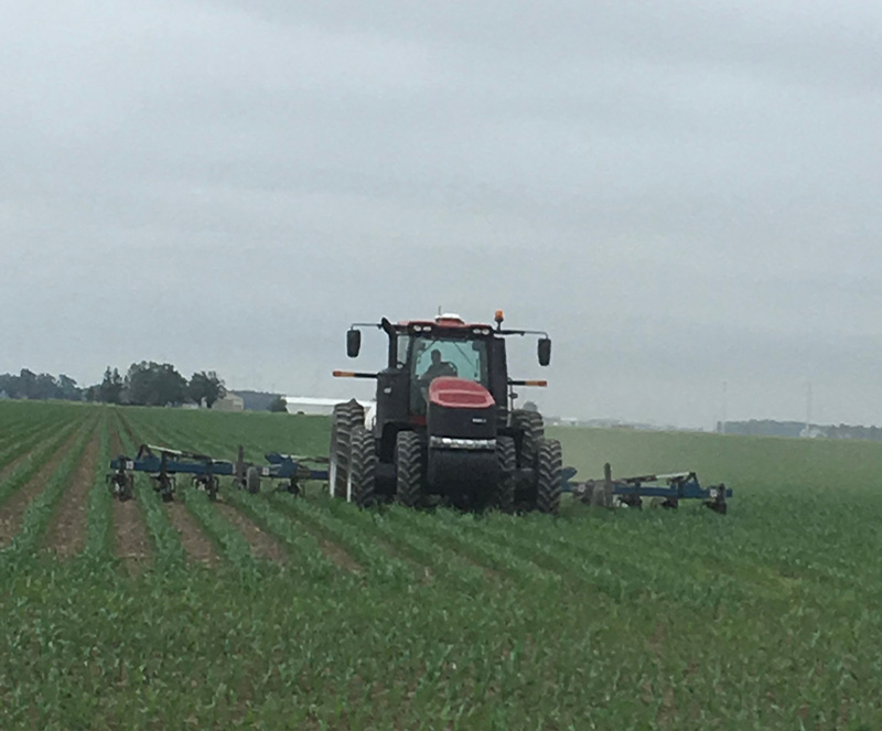 Tractor pulling a chopper in a field